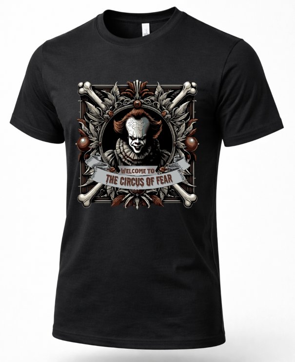 A black short-sleeve crewneck t-shirt featuring a large graphic print of Pennywise the Clown from IT. The graphic shows Pennywise framed by crossed bones, with a banner reading 'WELCOME TO THE CIRCUS OF FEAR'.