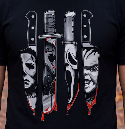 A black short-sleeve t-shirt featuring a graphic print of four horror movie knives with faces and blood splatters, worn by a person whose arms are visible at the sides.