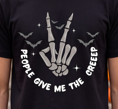 A close-up of a person wearing a black t-shirt with a gray and white graphic of a skeleton hand making a peace sign, surrounded by bats, stars, and the text 'PEOPLE GIVE ME THE CREEP'.