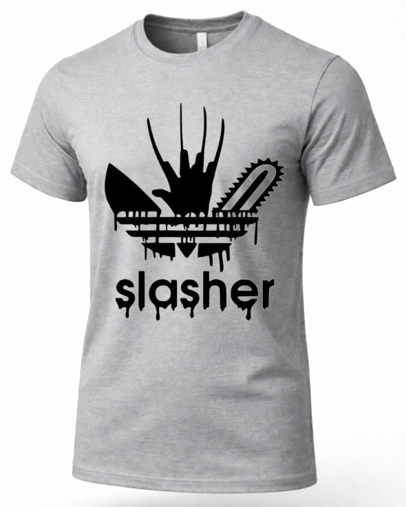 A heather gray short-sleeve crewneck t-shirt featuring a black graphic of a chainsaw and a bloody handprint with the word 'slasher' underneath, displayed on a clean white background.