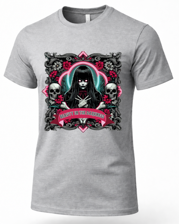 A heather gray short-sleeve crewneck t-shirt featuring a gothic-style graphic print on the front. The graphic depicts a dark-haired female figure with a black veil, flanked by skulls and pink roses, with a banner reading 'BEAUTY IN THE DARKNESS'.