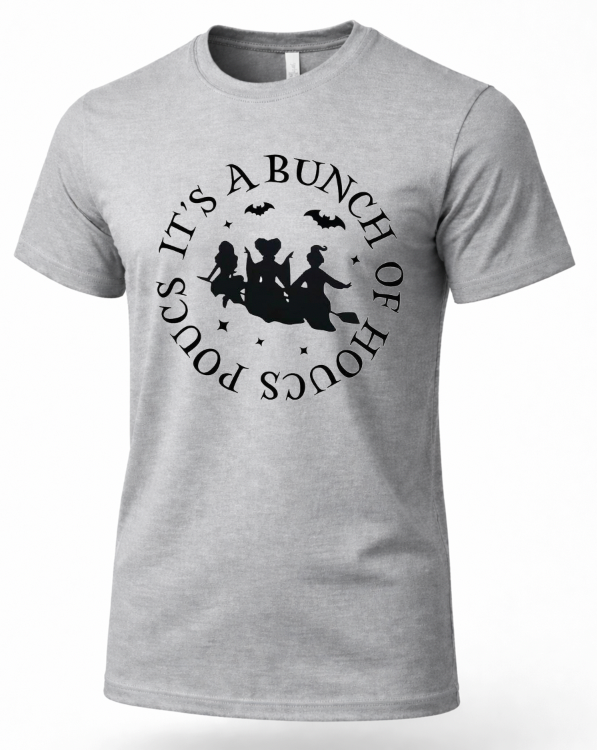 A heather gray short-sleeve crewneck t-shirt with a black circular graphic on the chest featuring three witches on a broomstick, bats, stars, and the text 'IT'S A BUNCH OF HOCUS POCUS'.