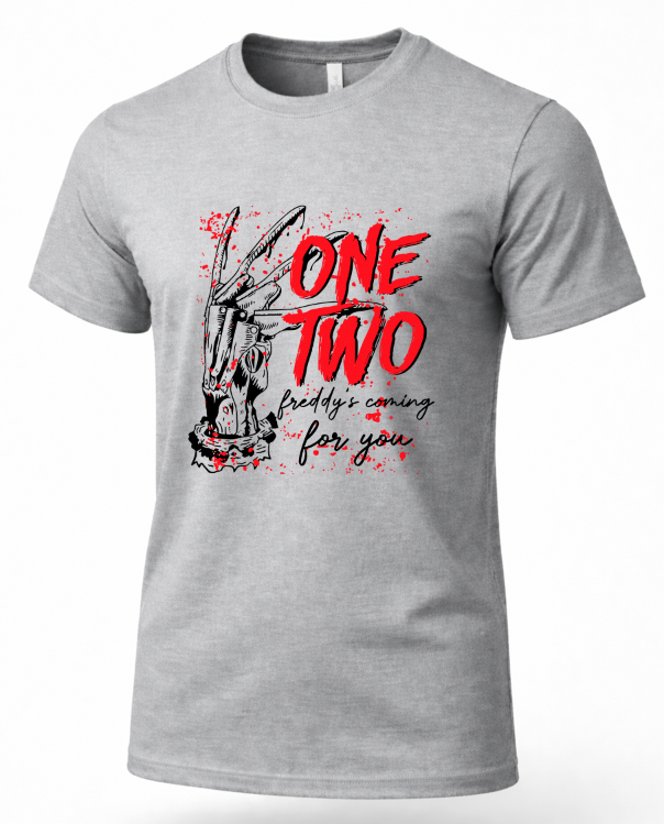 A heather gray short-sleeve t-shirt with a graphic print featuring a distressed rabbit illustration, red text reading 'ONE TWO', and black script text reading 'freddy's coming for you' on a white background.