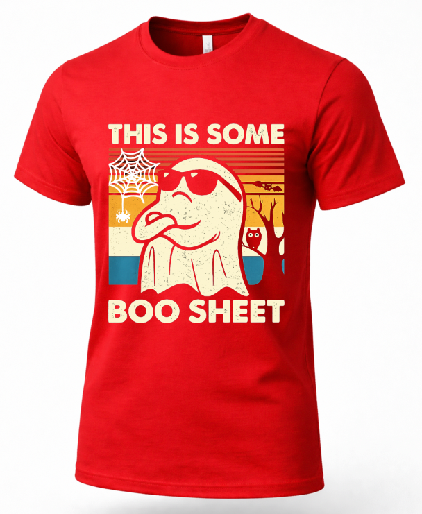 A red short-sleeve crewneck t-shirt featuring a retro-style graphic of a ghost wearing sunglasses with the text 'THIS IS SOME BOO SHEET' in cream lettering.