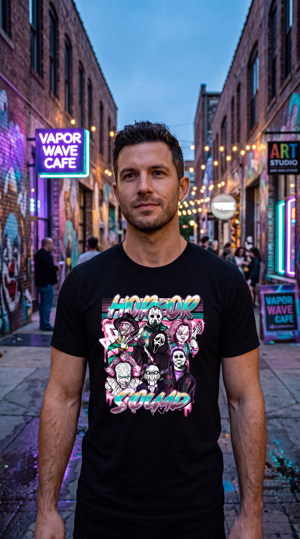 A smiling man wearing a black graphic t-shirt with a colorful 'Horror Squad' print, standing in front of a neon-lit street background.