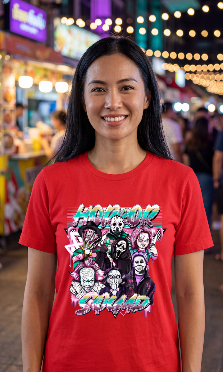 A smiling woman wearing a red graphic t-shirt with a colorful 'Horror Squad' print, standing in front of a neon-lit background.