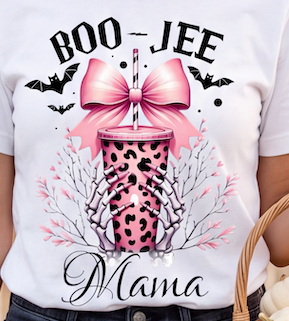 A white short-sleeve T-shirt with a large graphic print reading 'BOO-JEE Mama' in black script and bold lettering. The design features a pink leopard-print cup with a large pink bow, black bats, delicate pink floral branches, and dark gray outlines.