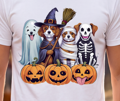 A white short-sleeve T-shirt worn by a person, featuring a colorful graphic print of four dogs dressed in Halloween costumes with three jack-o'-lantern pumpkins below them.