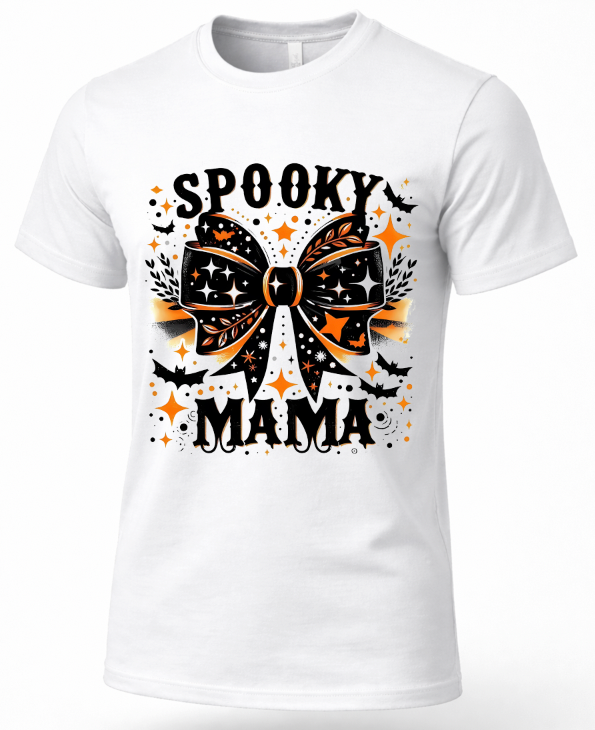 A white short-sleeve crewneck t-shirt featuring a Halloween graphic with the text 'SPOOKY MAMA' and a large black and orange bow design with bats and stars.