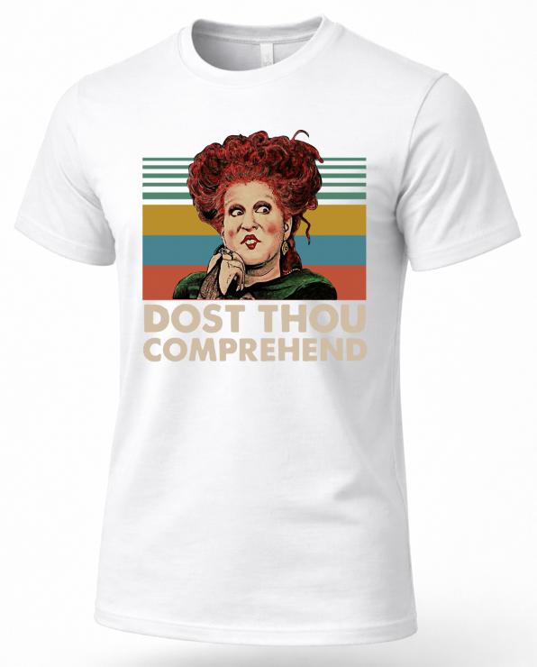 A white short-sleeve t-shirt featuring a retro-style graphic of the character Hallowell from The Three Brides with red hair, set against a striped background with the text 'DUST THOU COMPREHEND'.