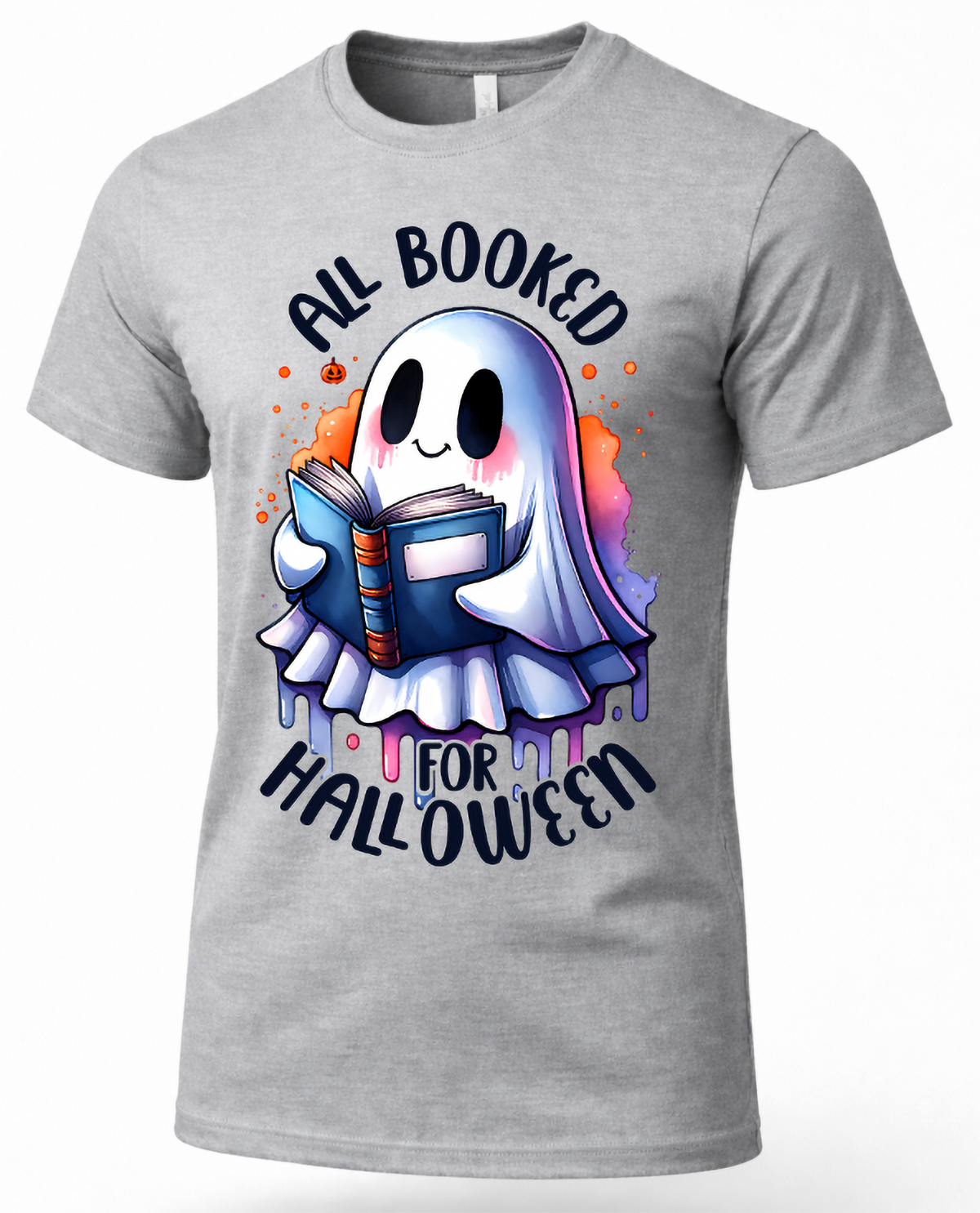 A heather gray short-sleeve crewneck t-shirt featuring a cartoon graphic of a cute ghost reading a blue book, surrounded by orange paint splatters and the text 'ALL BOOKED FOR HALLOWEEN' in a stylized font.