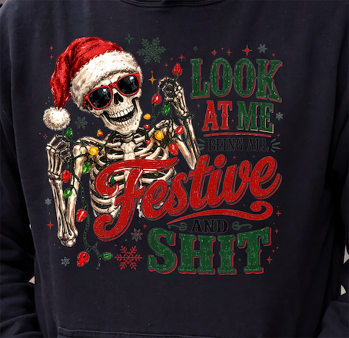 Close-up of black All Festive and Shit skeleton Christmas hoodie design