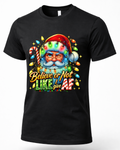 Black Mockup: Black unisex funny Christmas t-shirt featuring a winking Santa Claus wrapped in colorful Christmas lights with sarcastic holiday lettering.