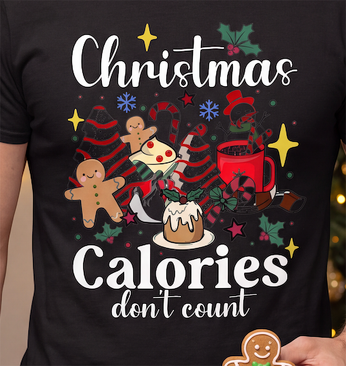Close-up of black Christmas Calories Don’t Count shirt featuring colorful holiday sweets and festive food artwork.