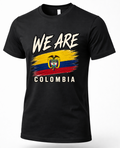 A black short-sleeve crewneck t-shirt featuring a distressed graphic of the Colombian flag with the text 'WE ARE' above and 'COLOMBIA' below in white.