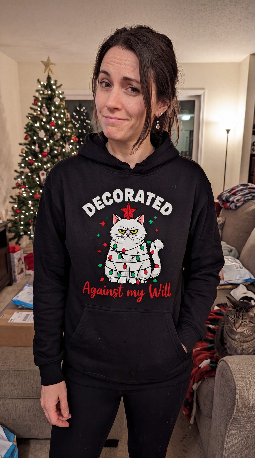 Woman wearing black funny cat Christmas hoodie with Decorated Against My Will design