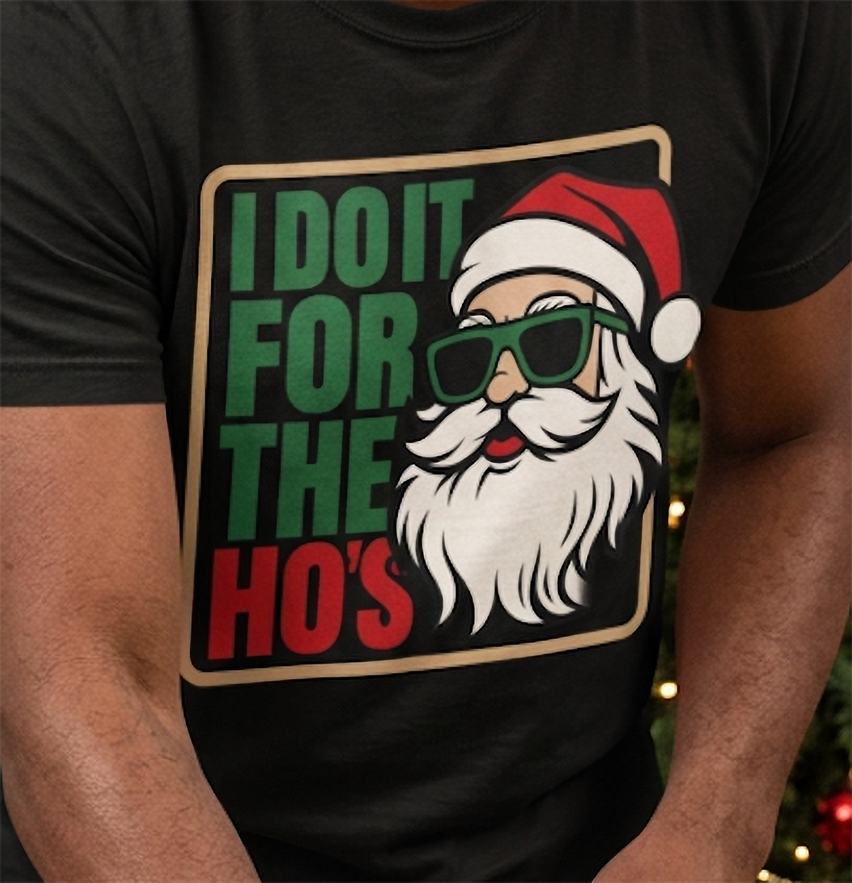 Close-up of funny Santa Christmas shirt design featuring green and red lettering and Santa wearing sunglasses on black fabric.