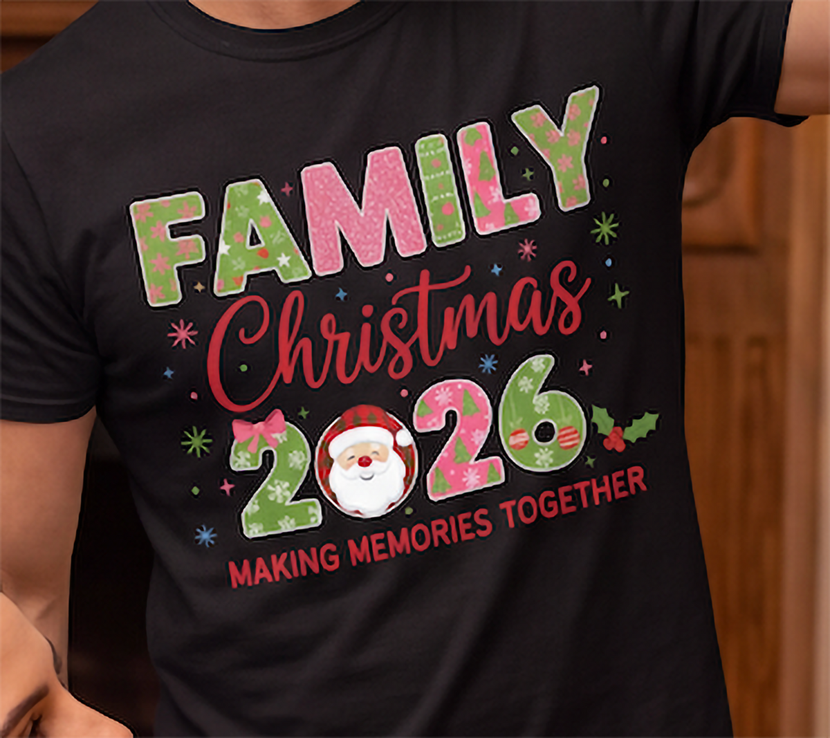 Close-up of black Family Christmas 2026 graphic tee with colorful holiday design and Santa.