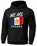 A black pullover hoodie featuring a distressed graphic of the French flag with the text 'WE ARE' above and 'FRANCE' below, displayed on a clean white background.