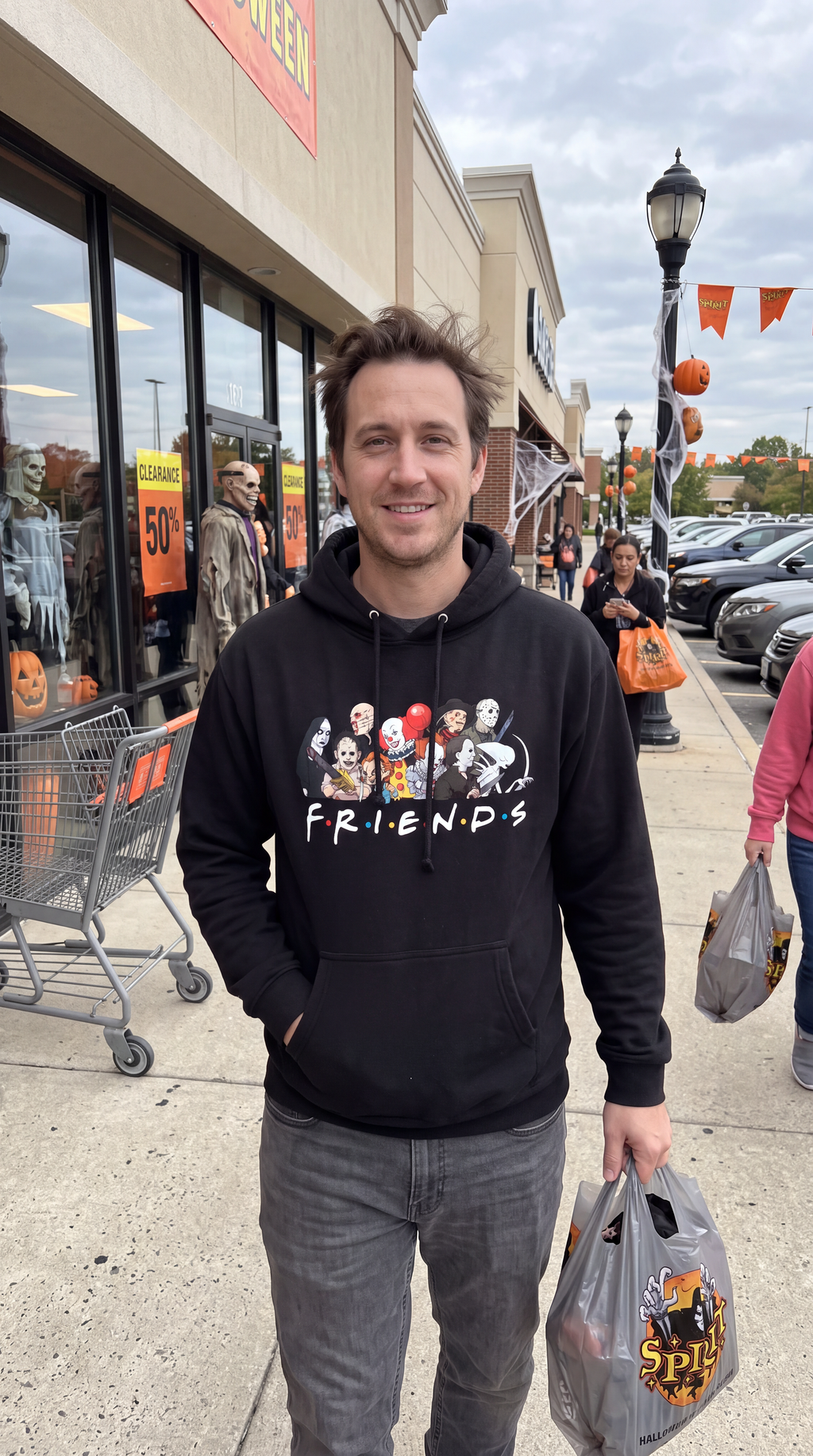 Man wearing black Horror Friends hoodie with classic scary movie characters