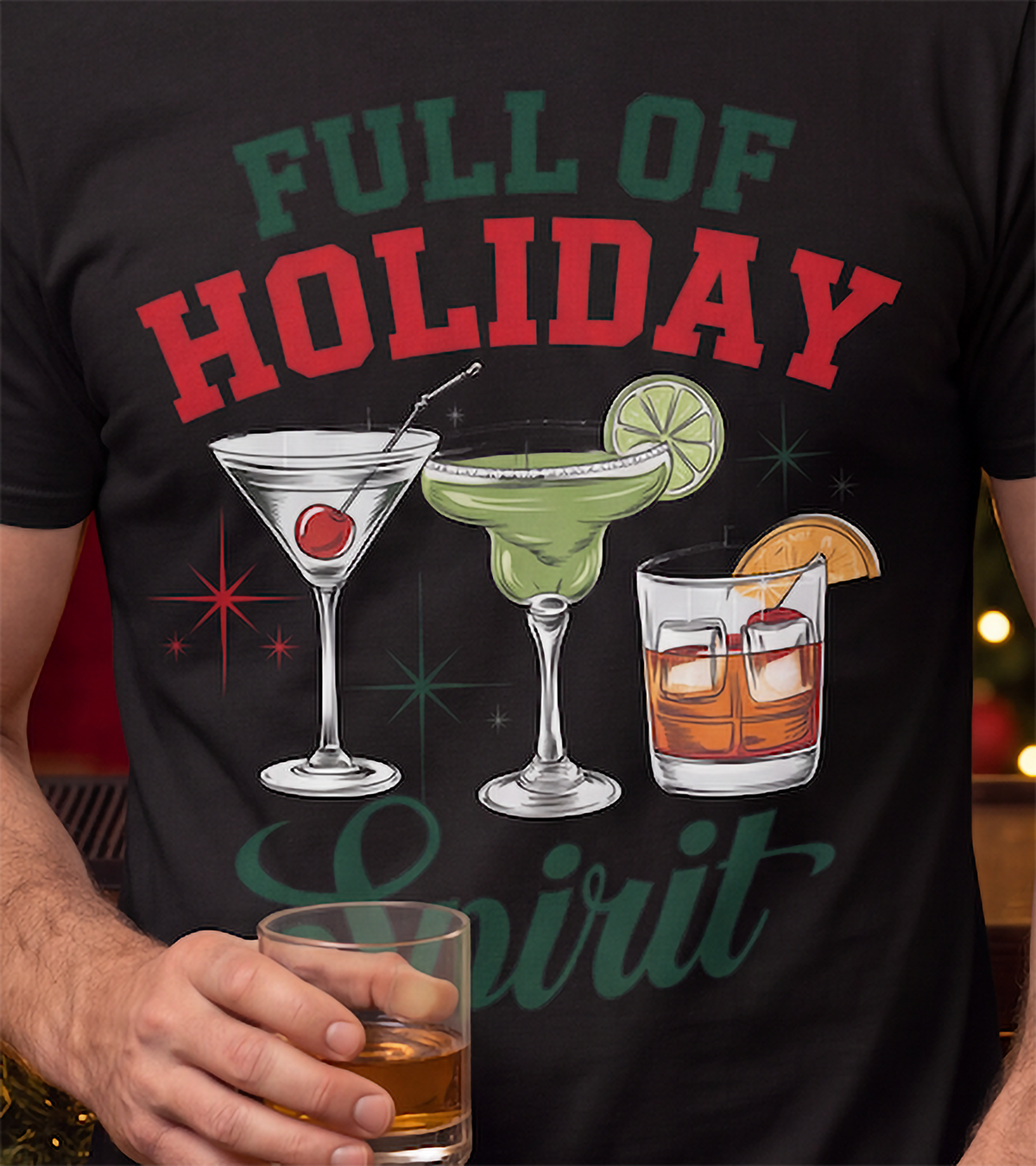 Close-up of Full of Holiday Spirit cocktail Christmas graphic on black shirt.