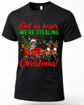 Black Christmas graphic tee featuring a raccoon stealing Santa’s sleigh with reindeer and Get in Loser We’re Stealing Christmas text.