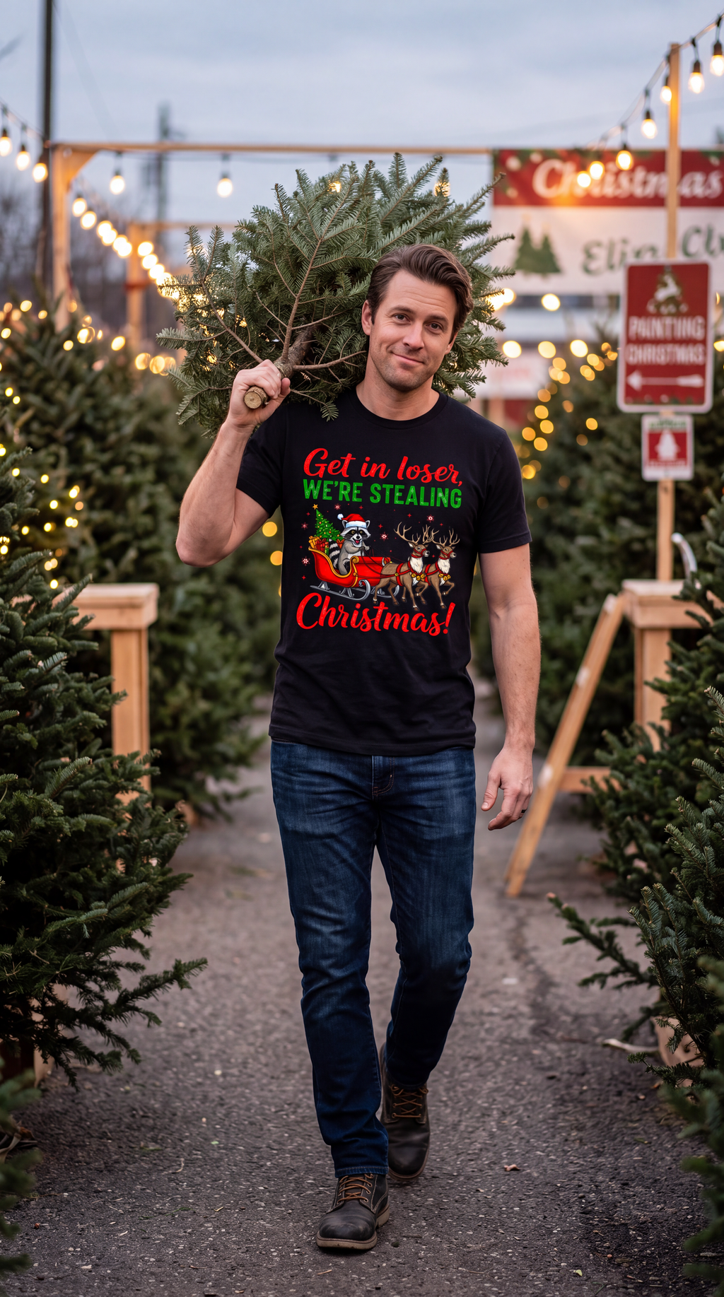 Man wearing a black Get in Loser We’re Stealing Christmas raccoon graphic tee while walking through an outdoor Christmas tree market.