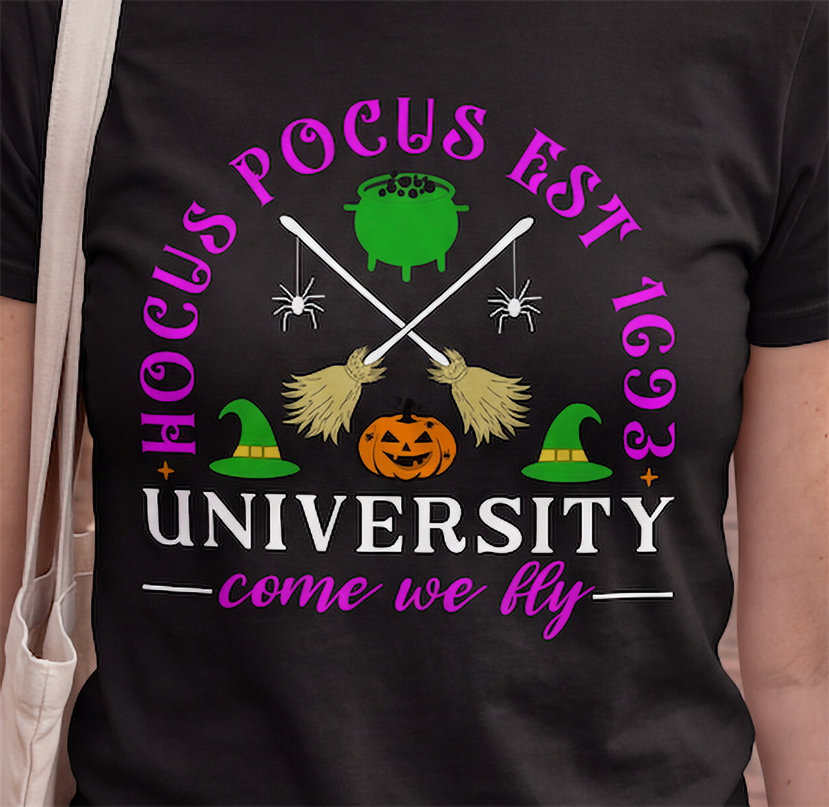 Close-up of black Hocus Pocus University Halloween shirt with witchy design
