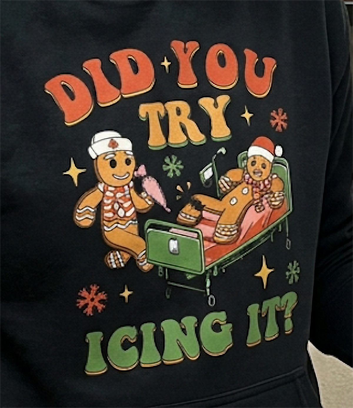 Close-up of Did You Try Icing It gingerbread medical graphic on black hoodie