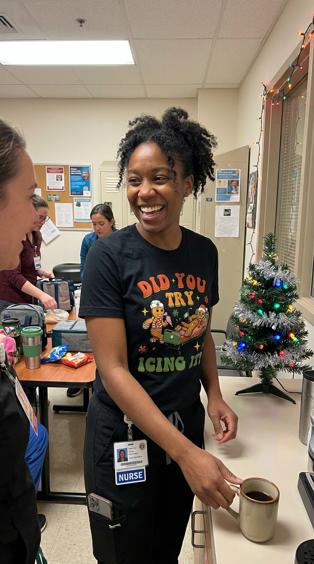 Woman wearing a black funny Christmas nurse shirt with gingerbread icing humor in a healthcare workplace.