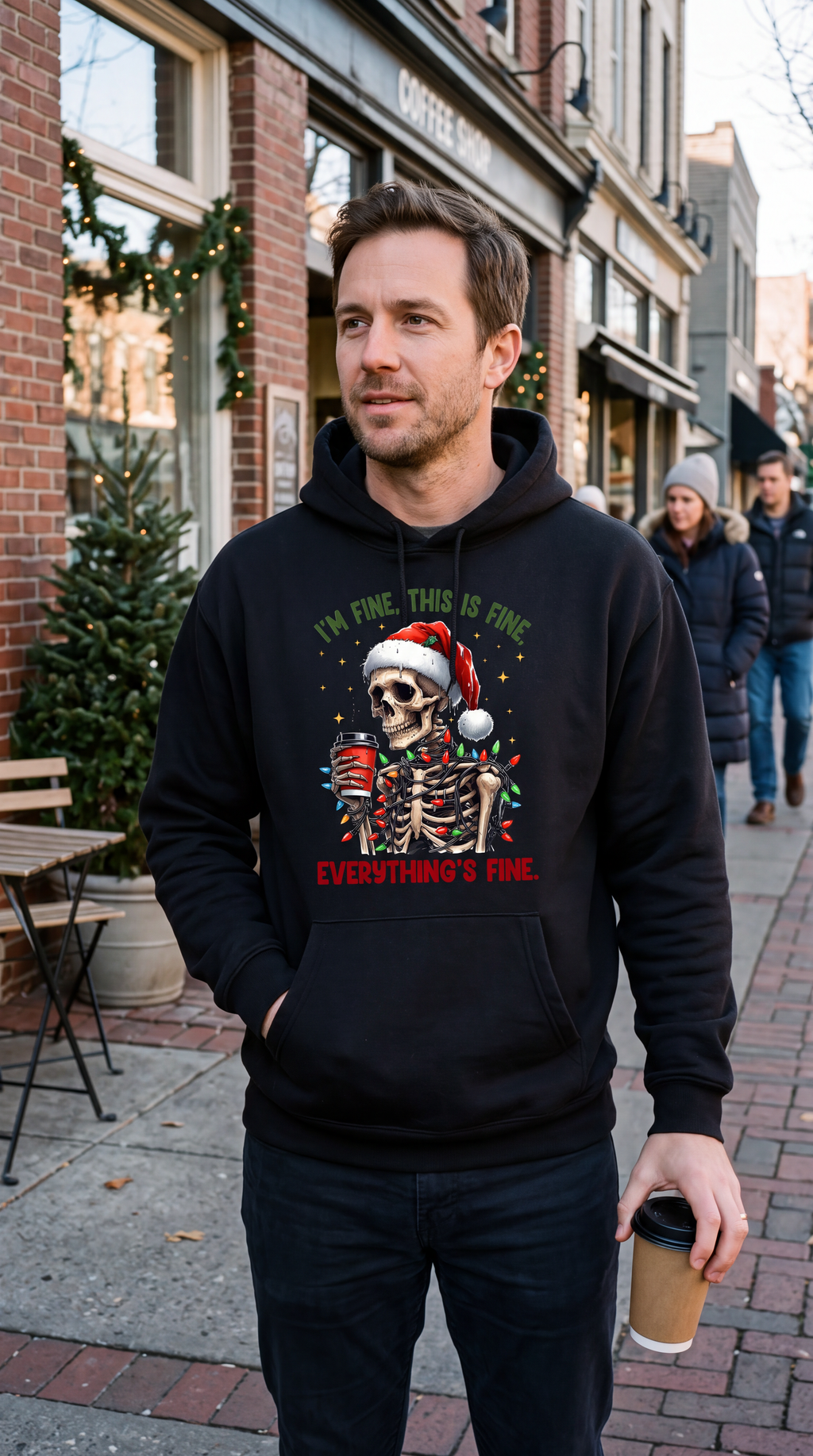 Man wearing black funny Christmas skeleton hoodie with I’m Fine Everything’s Fine design