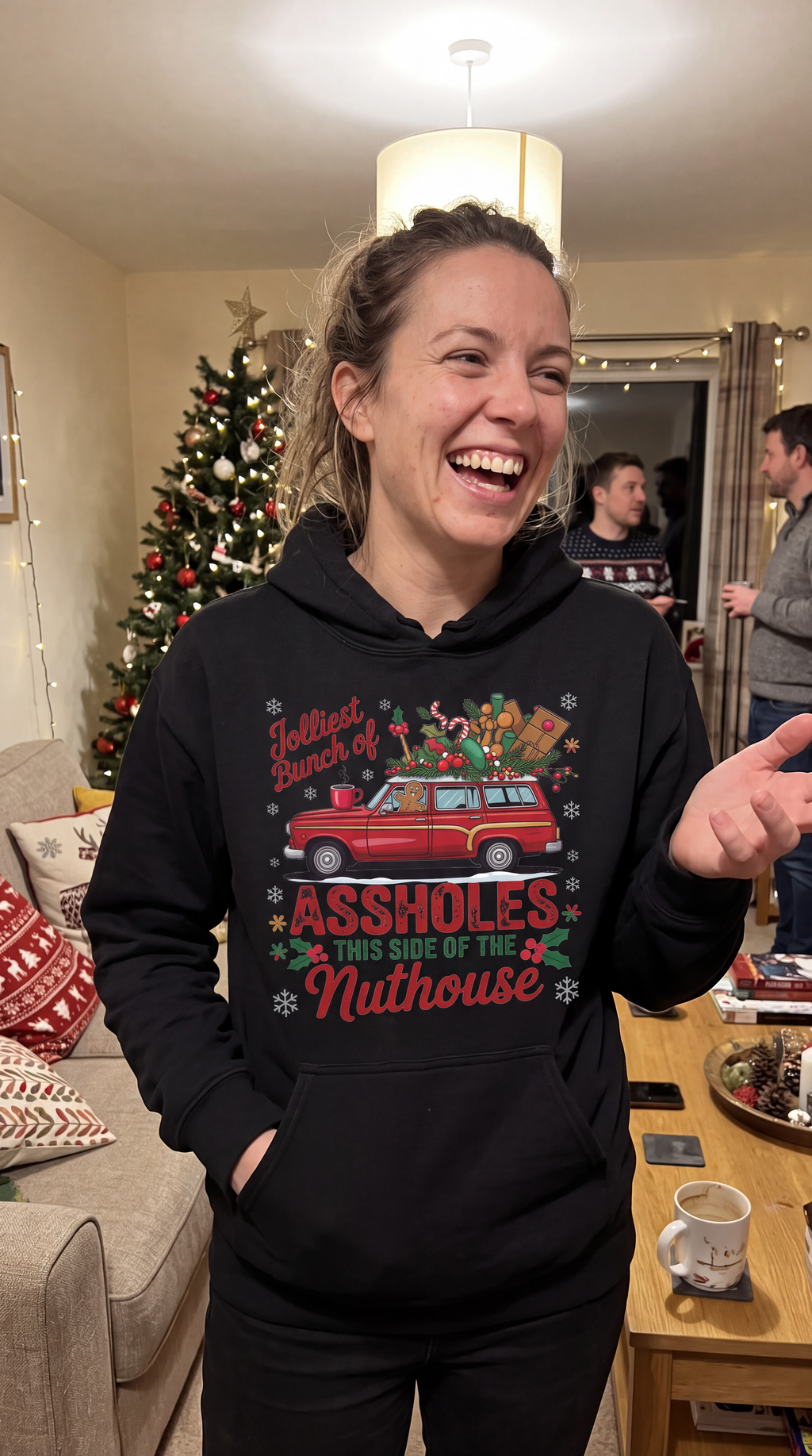Woman wearing black Jolliest Bunch funny family Christmas hoodie