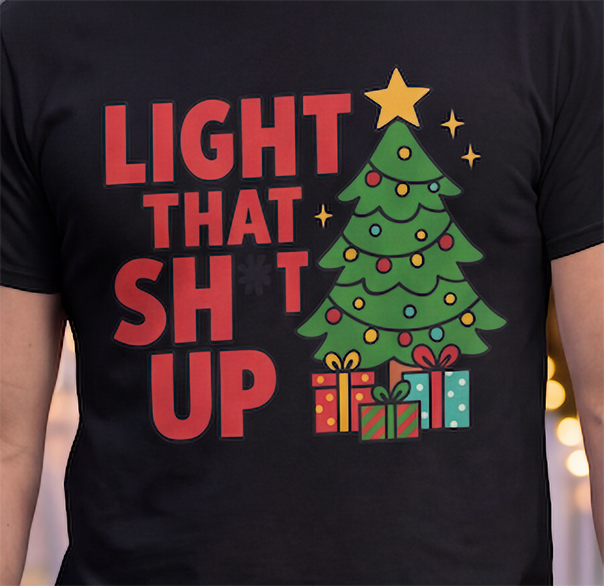 Close-up of black Light That Shit Up Christmas shirt showing bold red lettering and Christmas tree design.