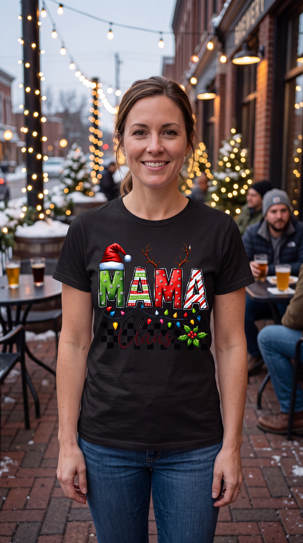 Woman wearing black Mama Claus Christmas graphic shirt outdoors in a casual holiday outfit