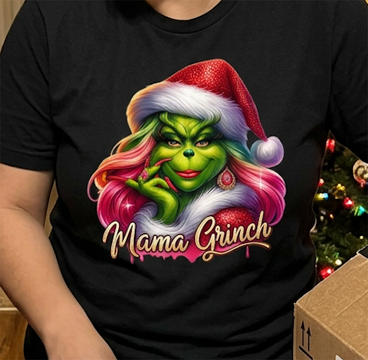 Close-up of black Mama Grinch shirt showing glamorous green Christmas character with pink hair and festive earrings.