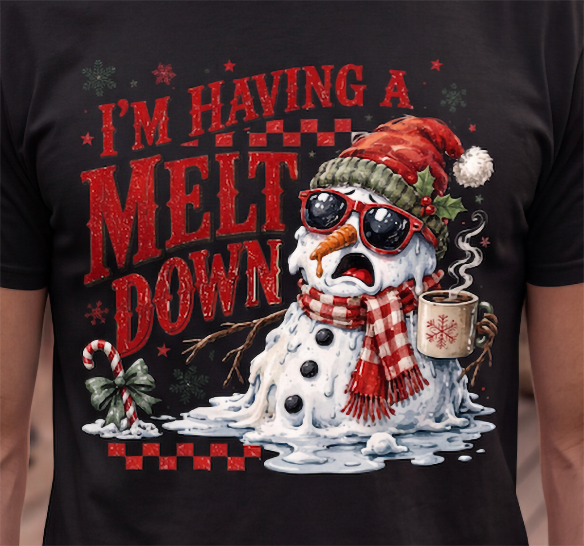 Close-up of black I’m Having a Meltdown Christmas shirt featuring melting snowman in sunglasses and Santa hat.