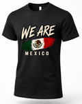 A black short-sleeve crewneck t-shirt featuring a distressed graphic print of the Mexican flag with the text 'WE ARE' above and 'MEXICO' below, displayed on a clean white background.