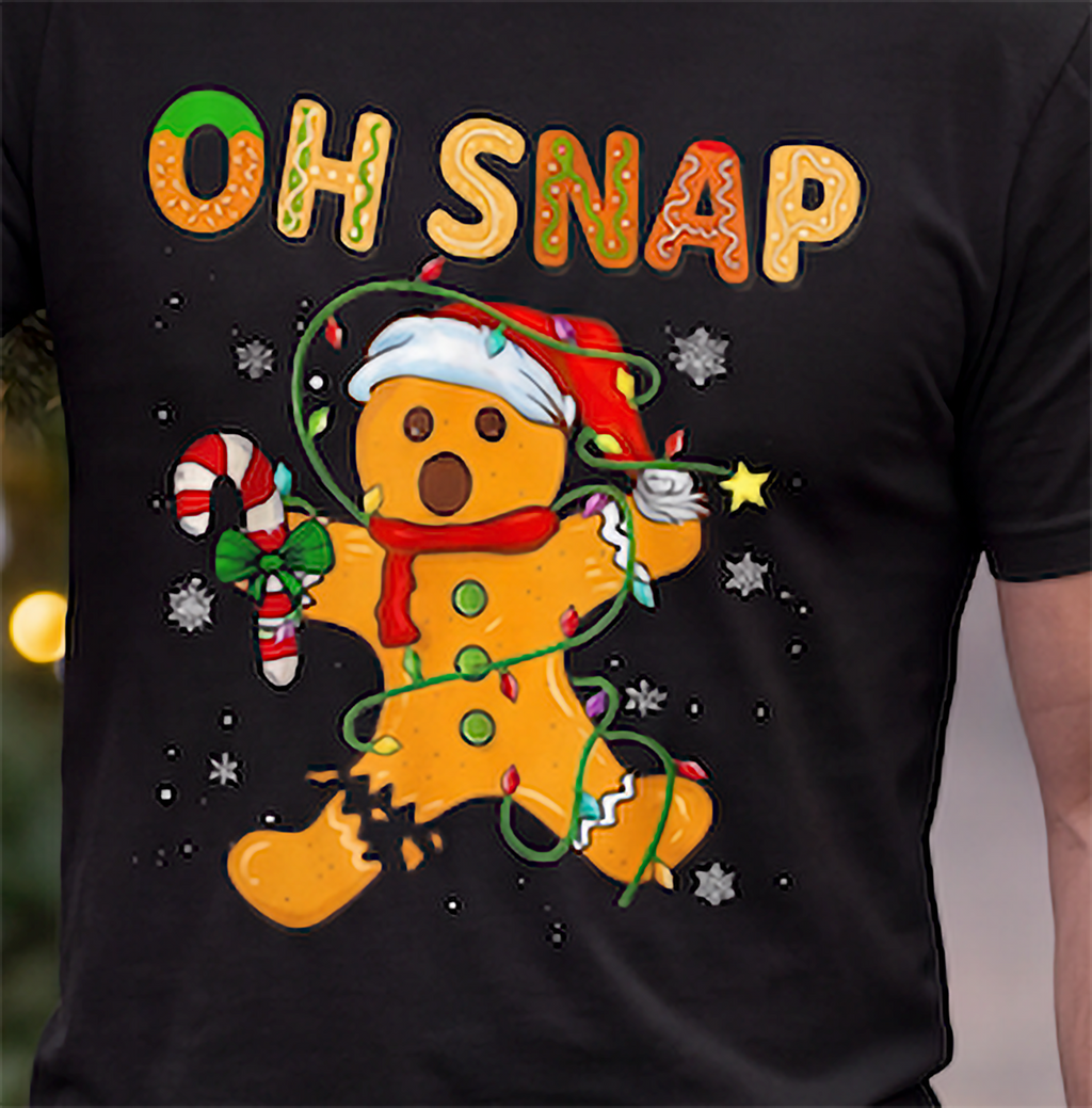 Close-up of colorful Oh Snap gingerbread Christmas design on black shirt