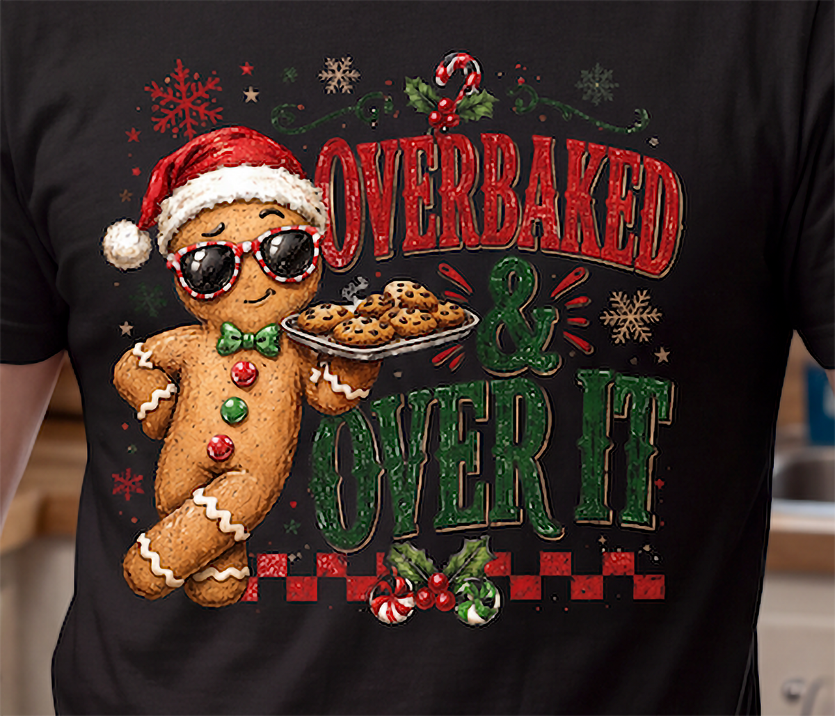 Close-up of Overbaked and Over It gingerbread Christmas design printed on black shirt.