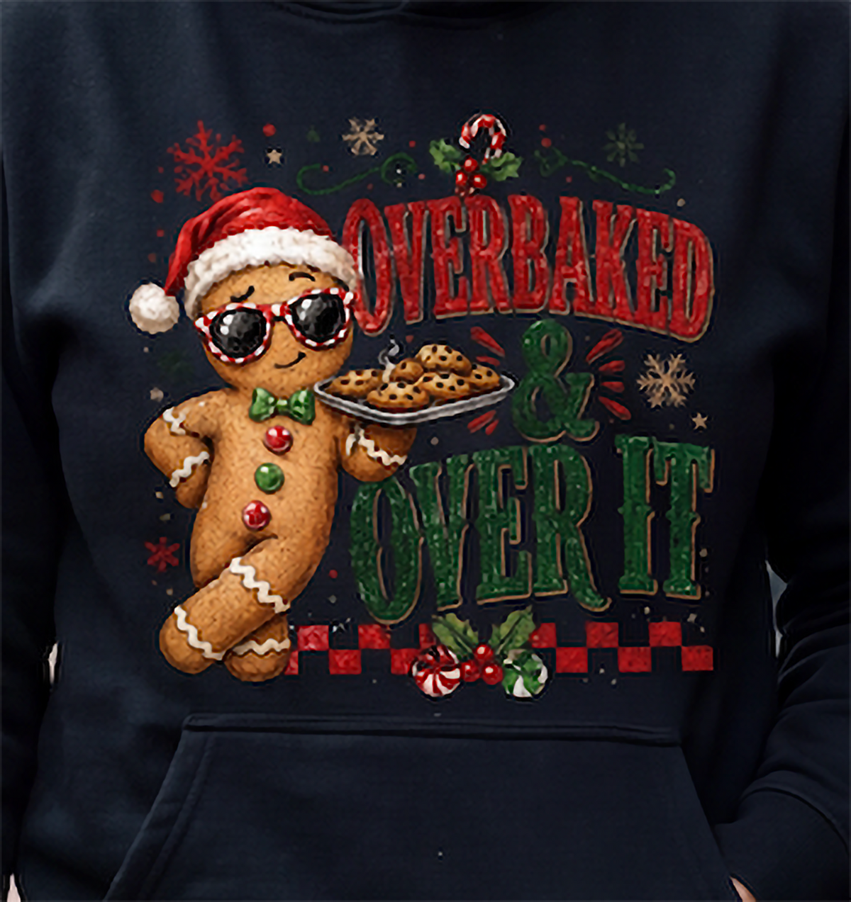 Close-up of black Overbaked and Over It Christmas gingerbread hoodie design