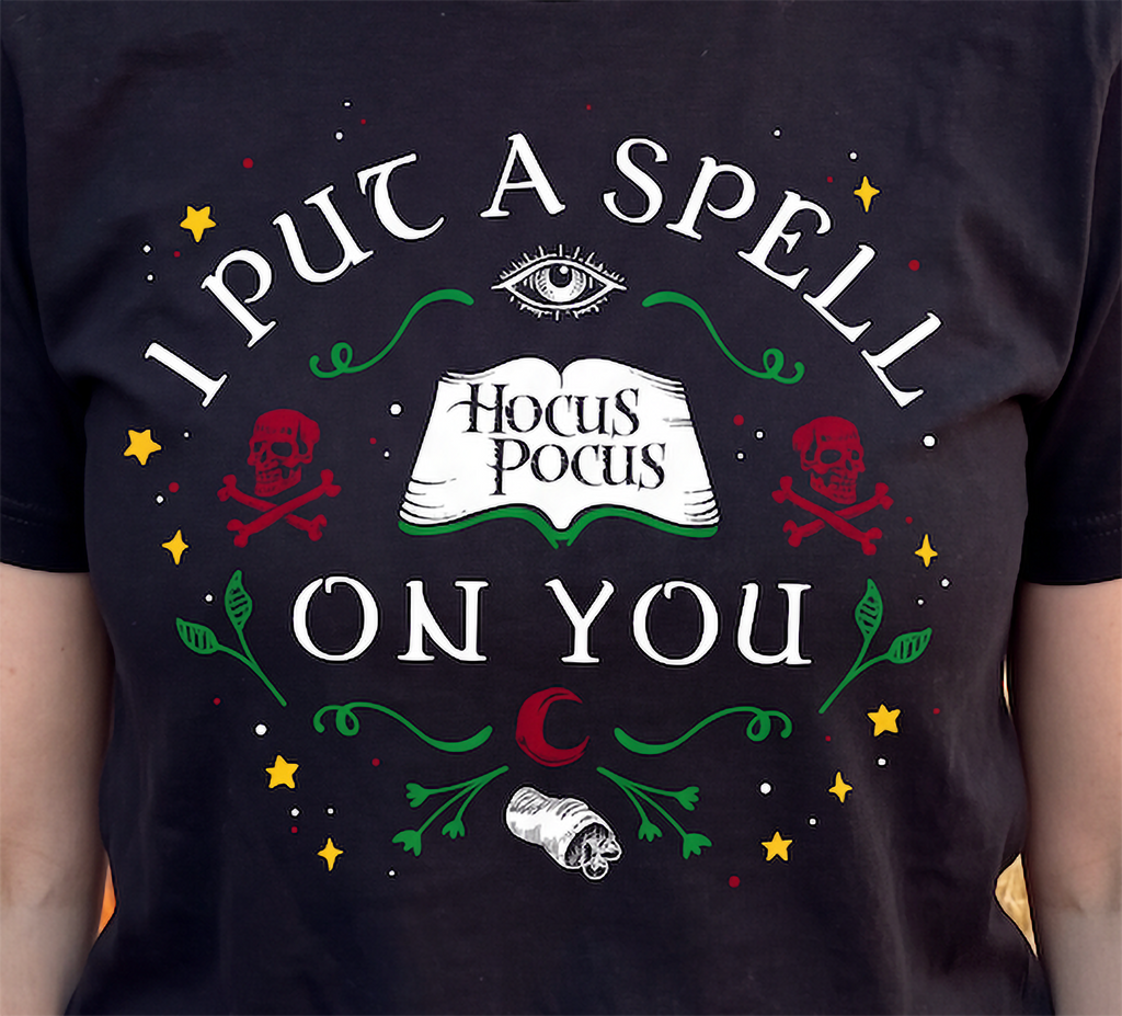 Close-up of black Hocus Pocus Halloween shirt with colorful witchy design