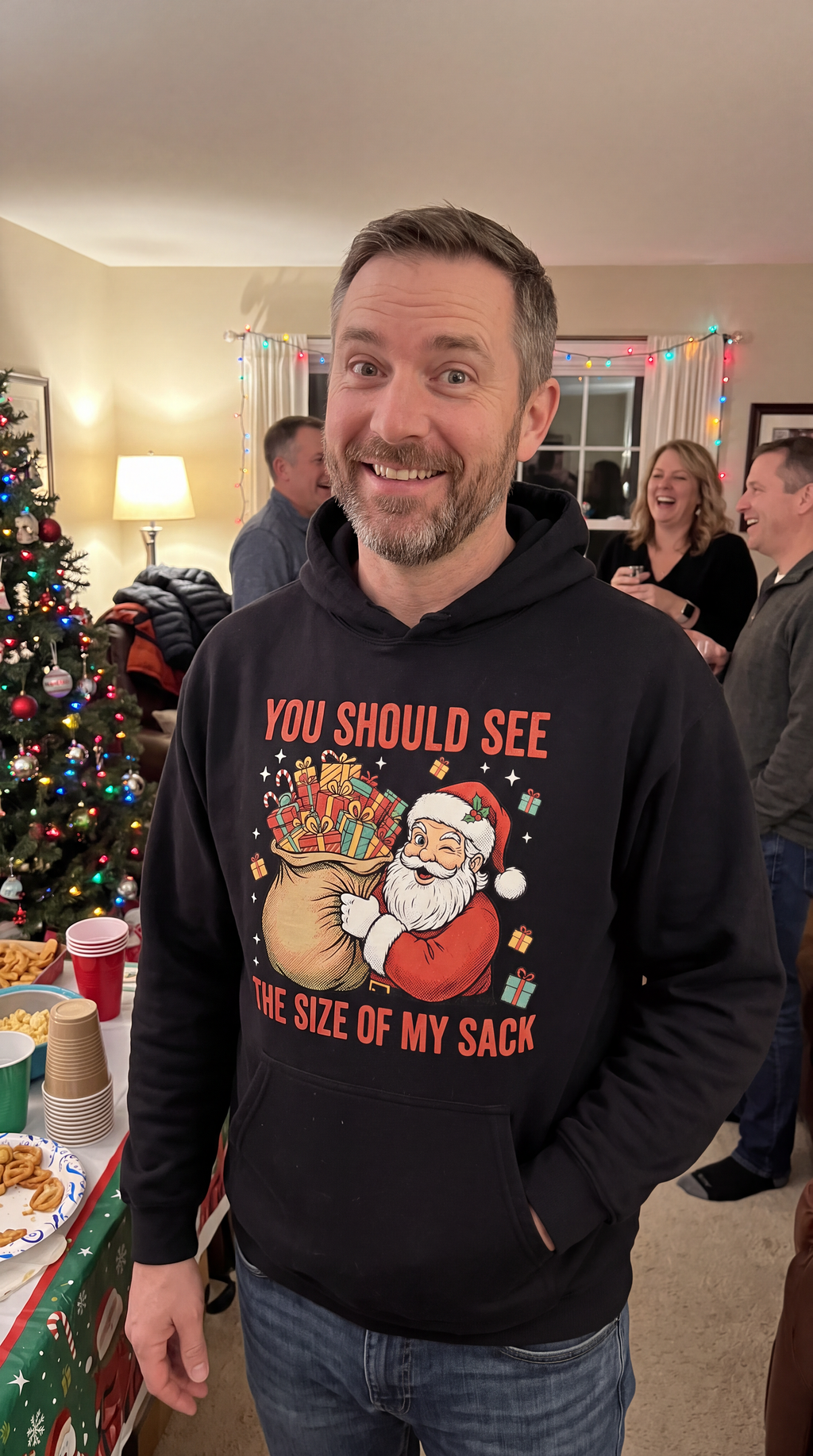 Man wearing black funny Santa Christmas hoodie with You Should See the Size of My Sack design