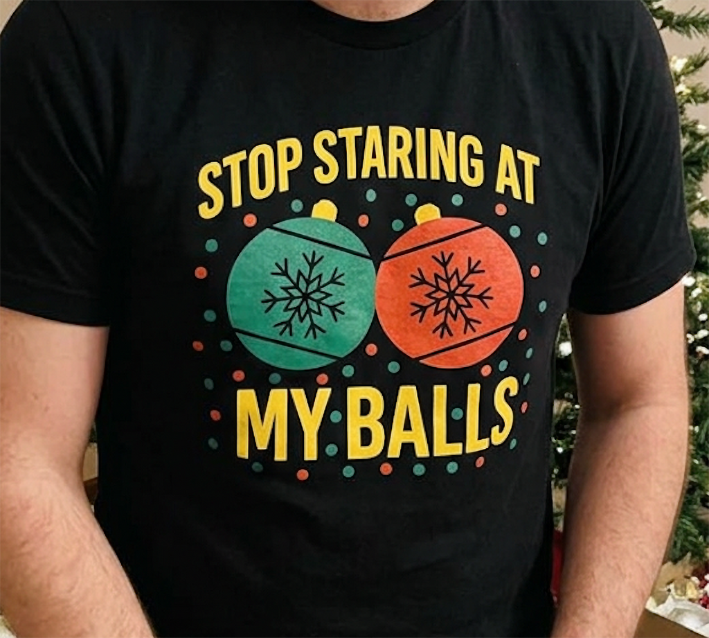 Close-up of black funny adult Christmas shirt showing red and green ornaments with bold yellow holiday lettering.