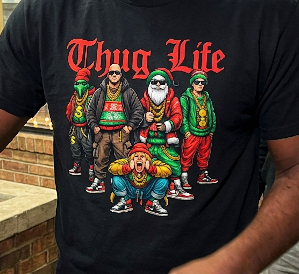 Close-up of black Thug Life Christmas graphic tee showing detailed festive hip hop characters and bold red lettering