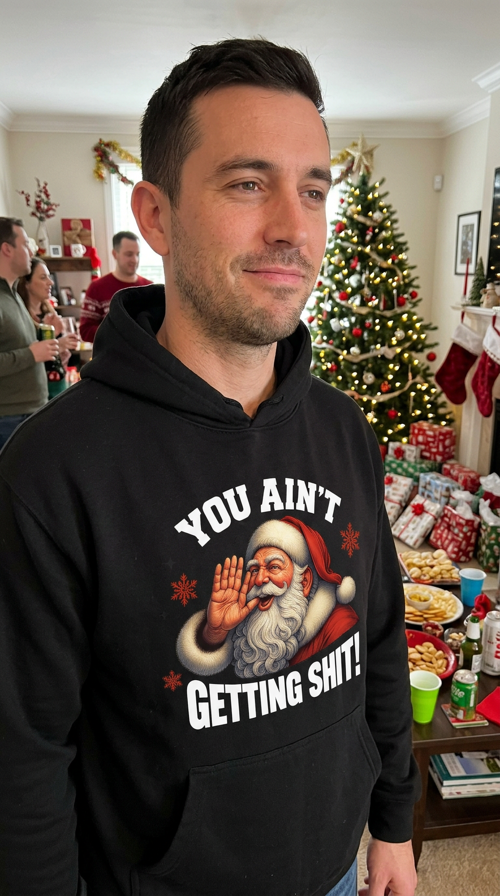 Man wearing black You Ain’t Getting Shit Santa hoodie at a Christmas party