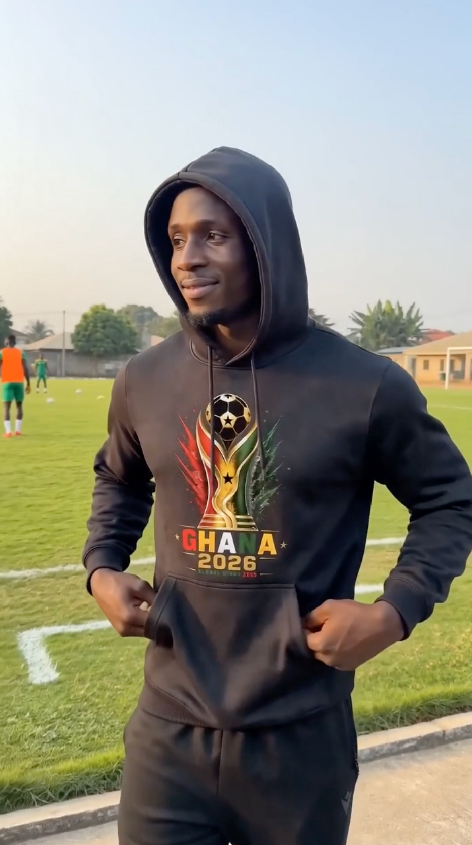 Black Ghana Soccer Hoodie 2026 featuring football trophy graphic in Ghana flag colors red yellow green and black
