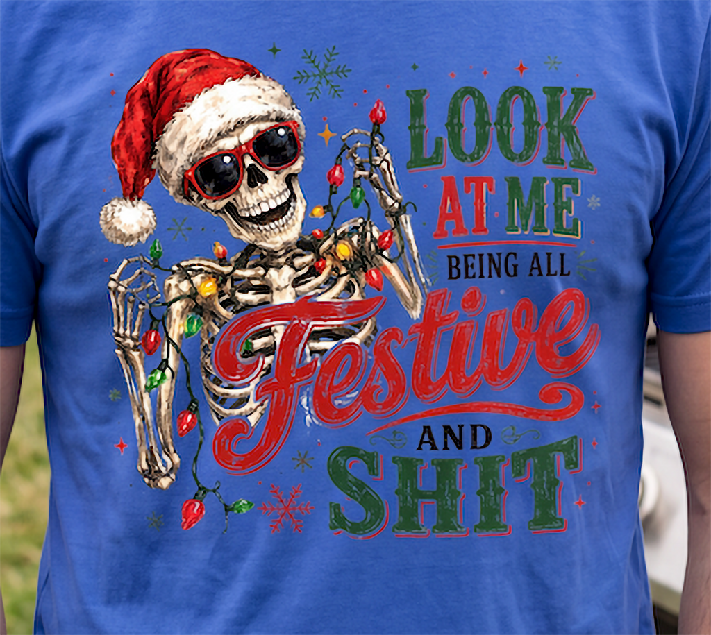 Blue close-up: Close-up of funny Santa skeleton Christmas graphic with colorful lights printed on blue shirt.
