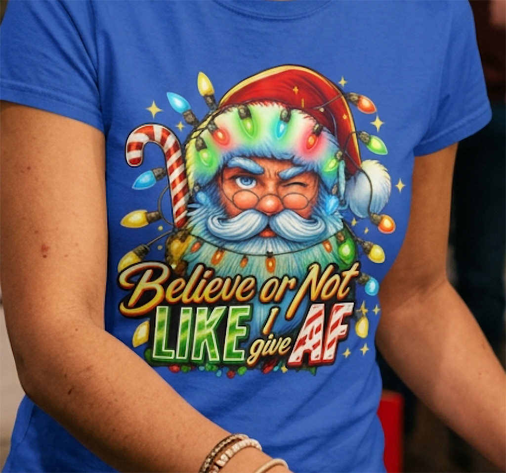 Blue Close-Up: Detailed view of the Believe or Not Like I Give AF Christmas graphic printed on blue fabric with winking Santa and multicolored lights.