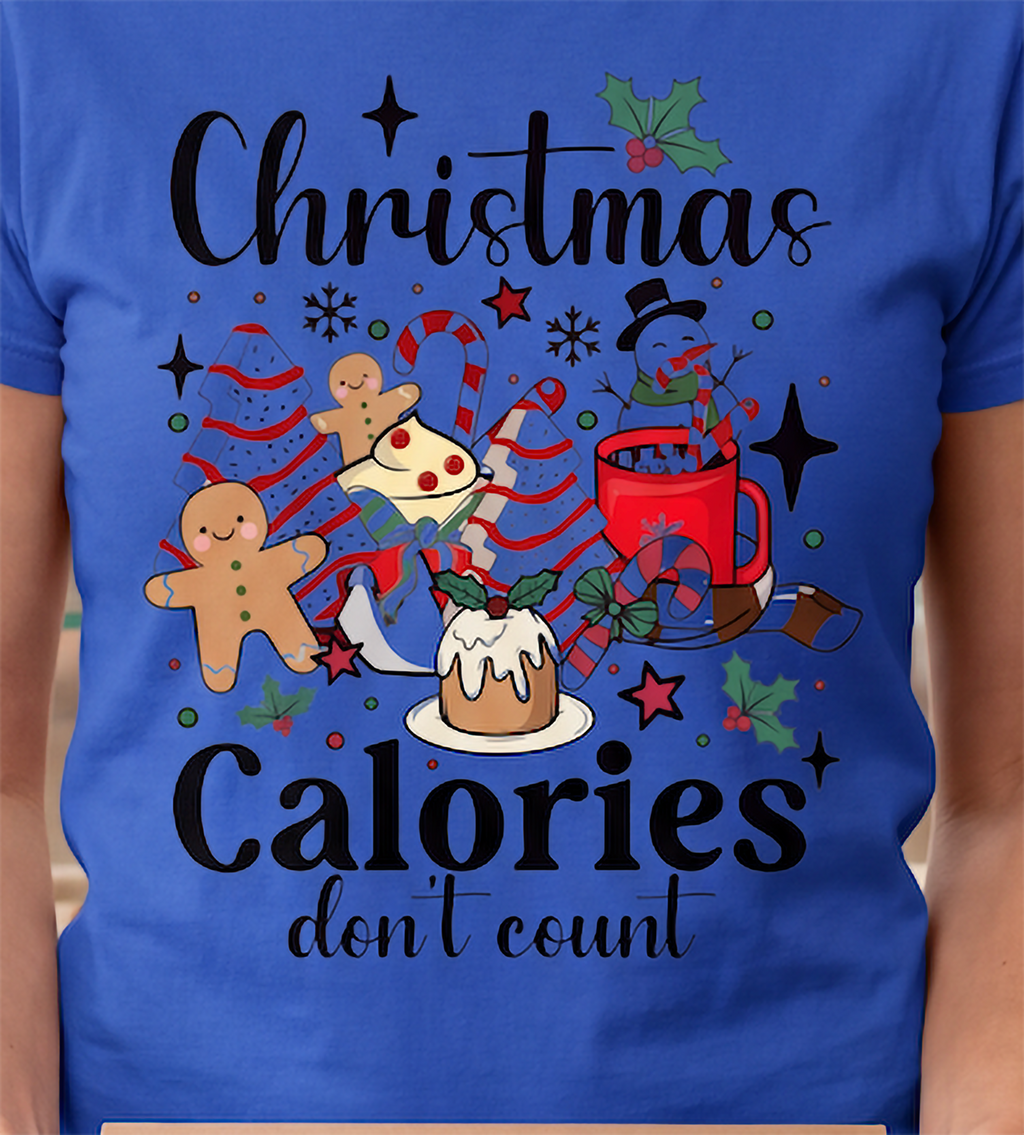 Close-up of royal blue Christmas Calories Don’t Count shirt featuring colorful festive food artwork.