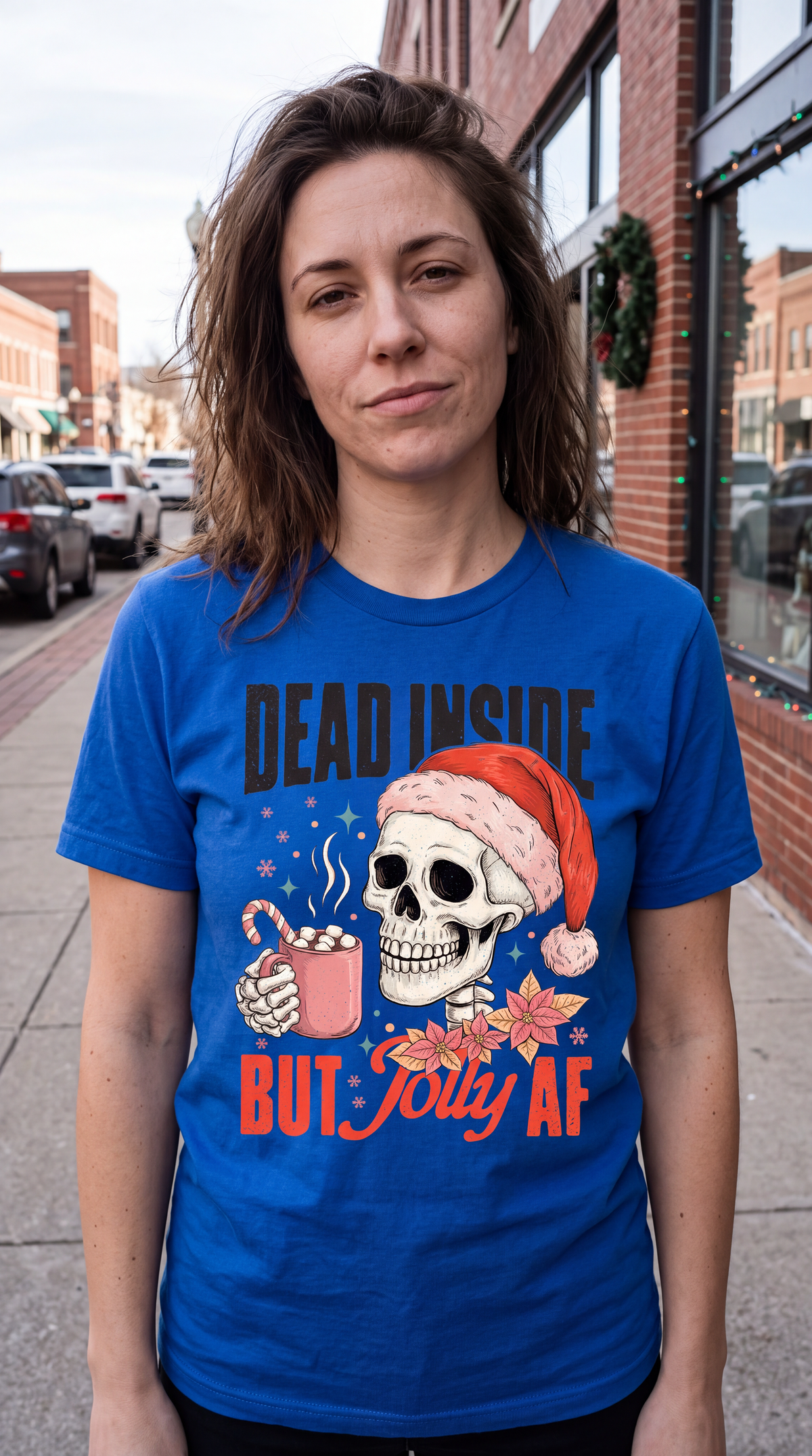 Woman wearing blue Dead Inside But Jolly AF funny skeleton Christmas graphic tee.